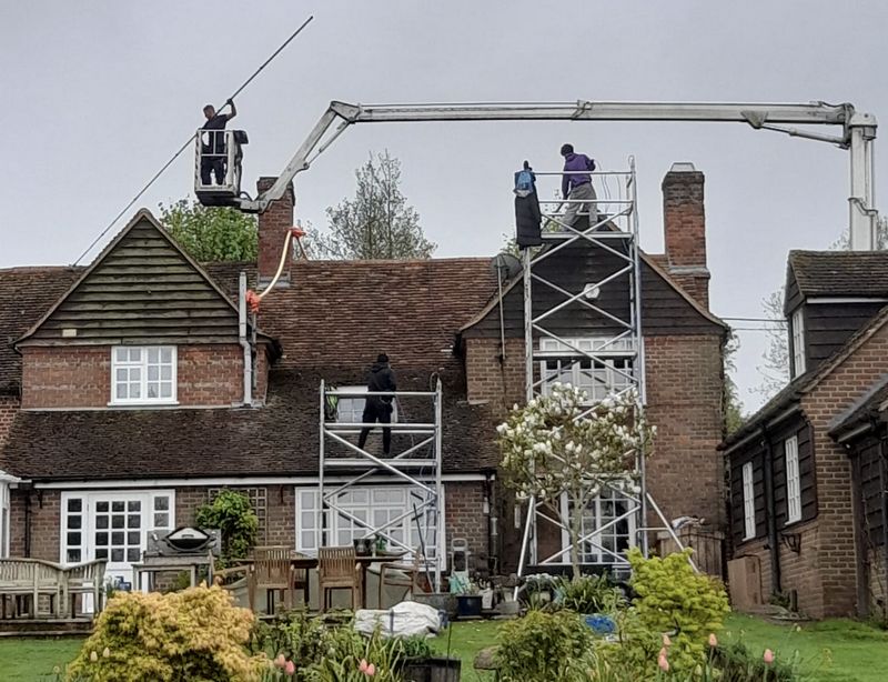 The Roof Moss Cleaners using cherry picker and scaffolding to clean roof safely and professionally in North Baddesley, Hampshire